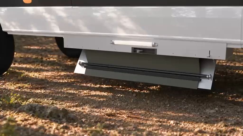 Concept render: the BaseRoll housing door lowering beneath a white camper van on a forest campsite.